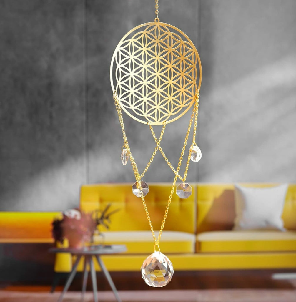 Flower of Life Crystal Ascending Suncatcher hanging on a white wall
